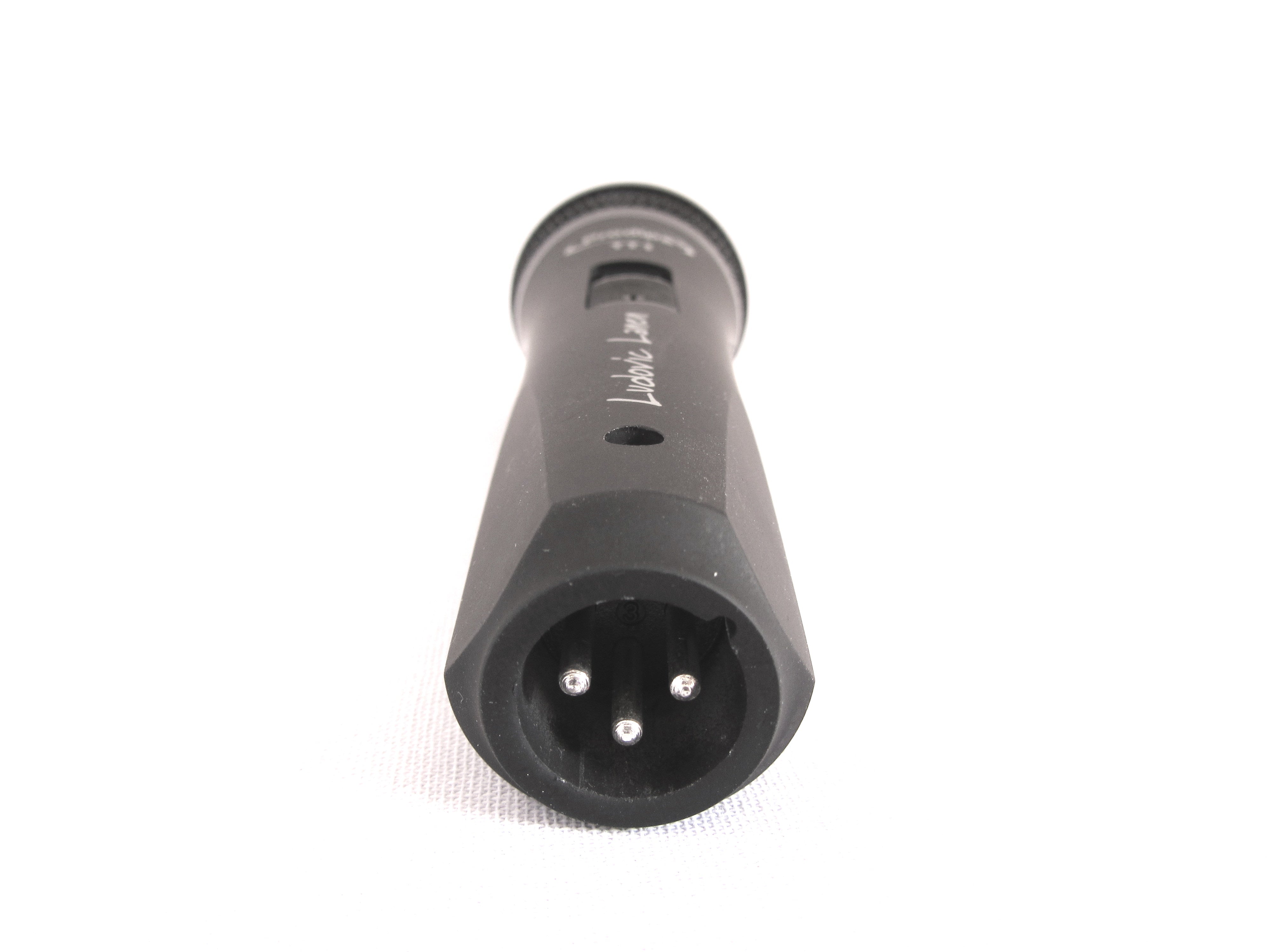 Black handheld microphone with a visible three-pin XLR connector facing forward, used for audio recording.