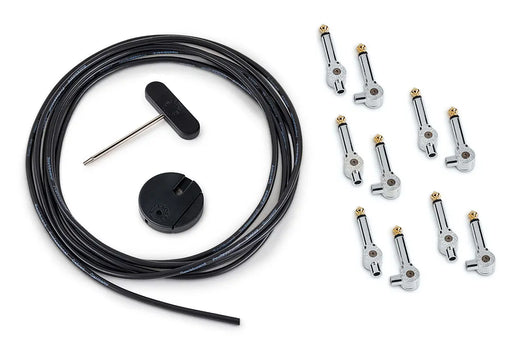 Guitar pedalboard cable kit including a long black cable, ten right-angle plugs, a round cable cutter, and a T-handle screwdriver.