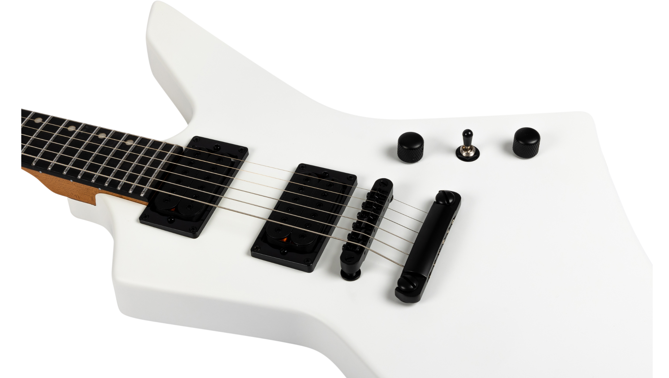 White electric guitar with an angular body, black pickups, bridge, two control knobs, and a small toggle switch. Six strings and a dark fretboard.