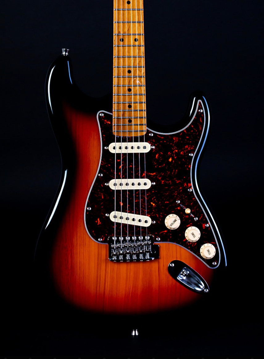 Sunburst electric guitar with three white single-coil pickups, tortoiseshell pickguard, maple neck, and three cream control knobs.