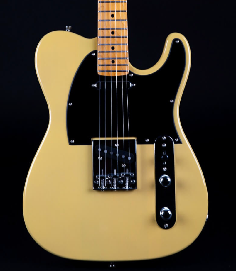 Cream-colored electric guitar with a black pickguard, two control knobs, six strings, and a maple neck visible against a black background.