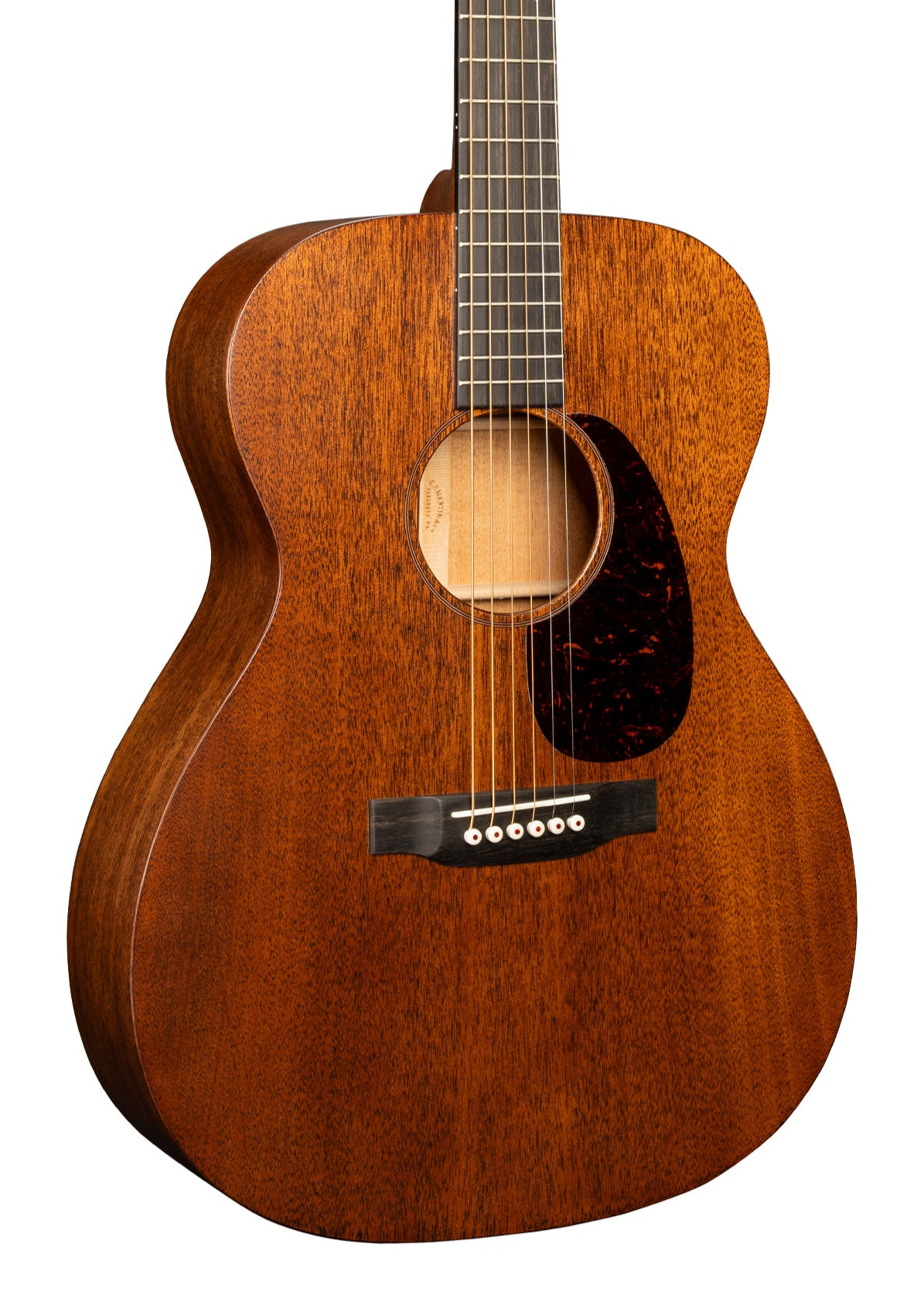 Mahogany acoustic guitar with six strings, a dark tortoiseshell pickguard, and a round soundhole. The body has a smooth, matte wood finish.