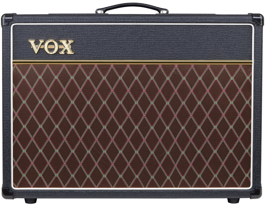 Amplificateur Vox rectangulaire noir avec poignée sur le dessus, façade en tissu marron à motif losange doré, logo Vox doré en haut à gauche.