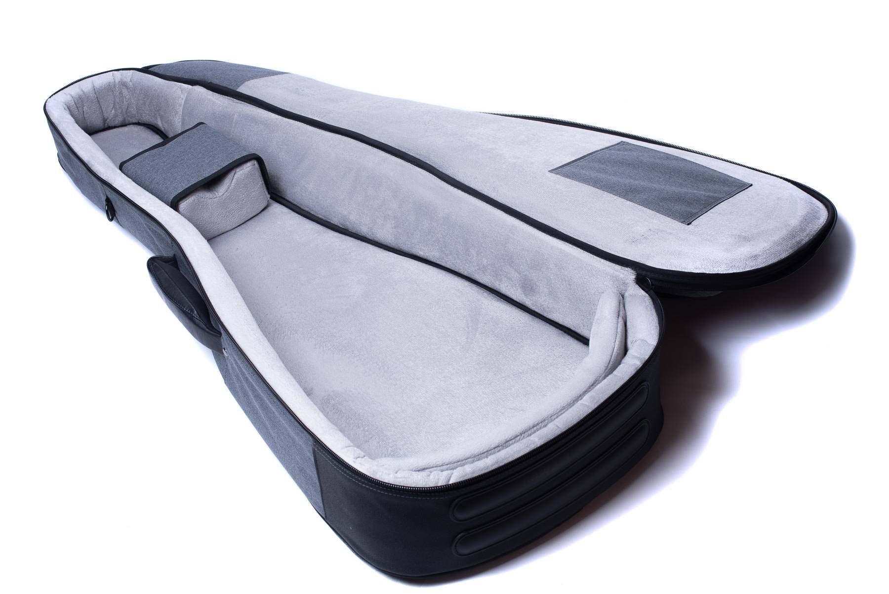 Open, empty soft case for an acoustic guitar with padded grey interior, raised neck support, and a flat pocket on the inside lid.