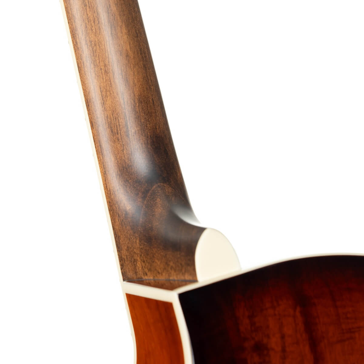 Close-up of an acoustic guitar’s neck joint, showing smooth brown wood grain and cream-colored binding along the edges.