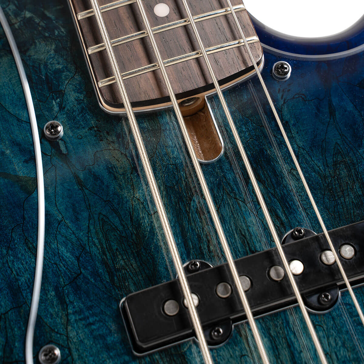 Close-up of blue electric bass body with four metal strings, black pickup, and a wood-grain pattern visible beneath the strings.