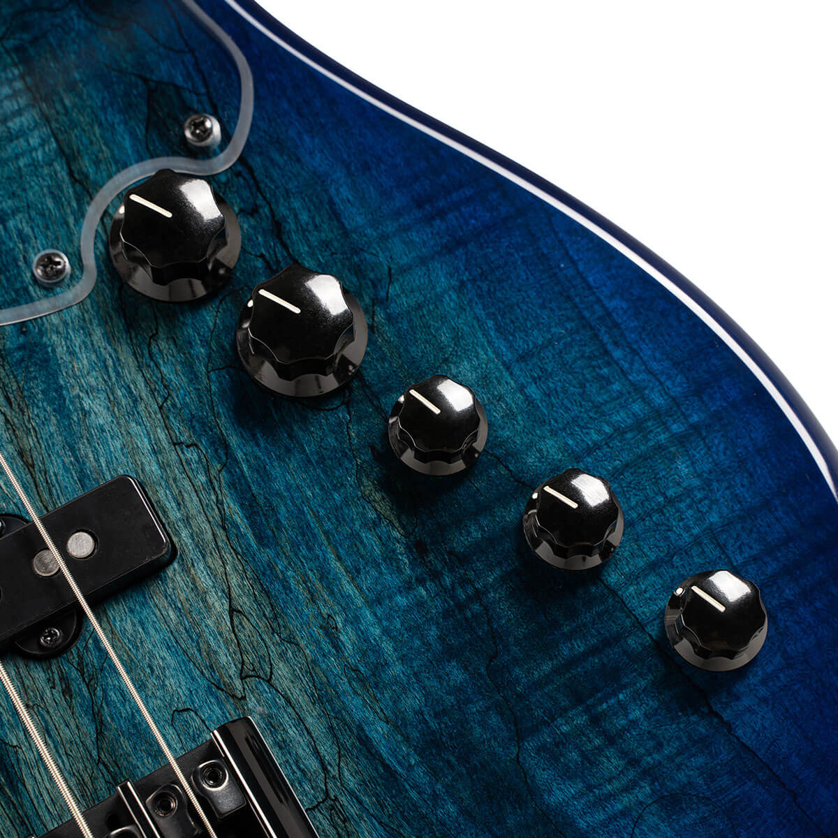 Five black control knobs and part of the pickups on a blue wood-grain electric bass guitar body.