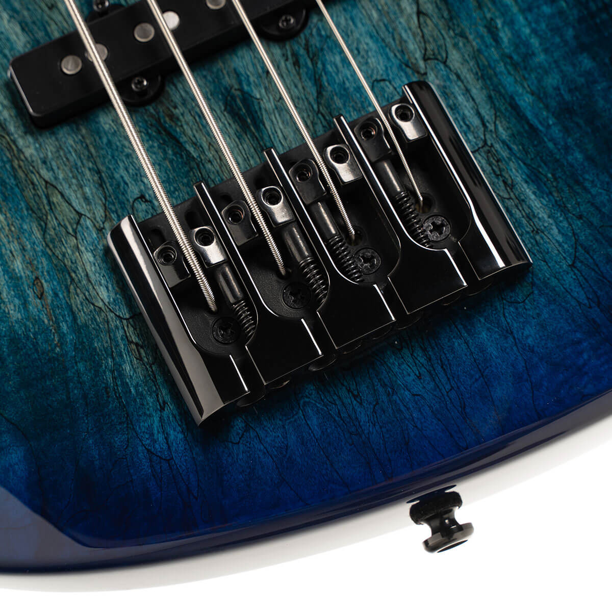 Close-up of an electric bass bridge with four metal strings over a glossy blue wood grain finish.