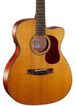 Light brown acoustic guitar with a cutaway body, dark wood sides, a circular sound hole, and a red tortoiseshell pickguard below the strings.