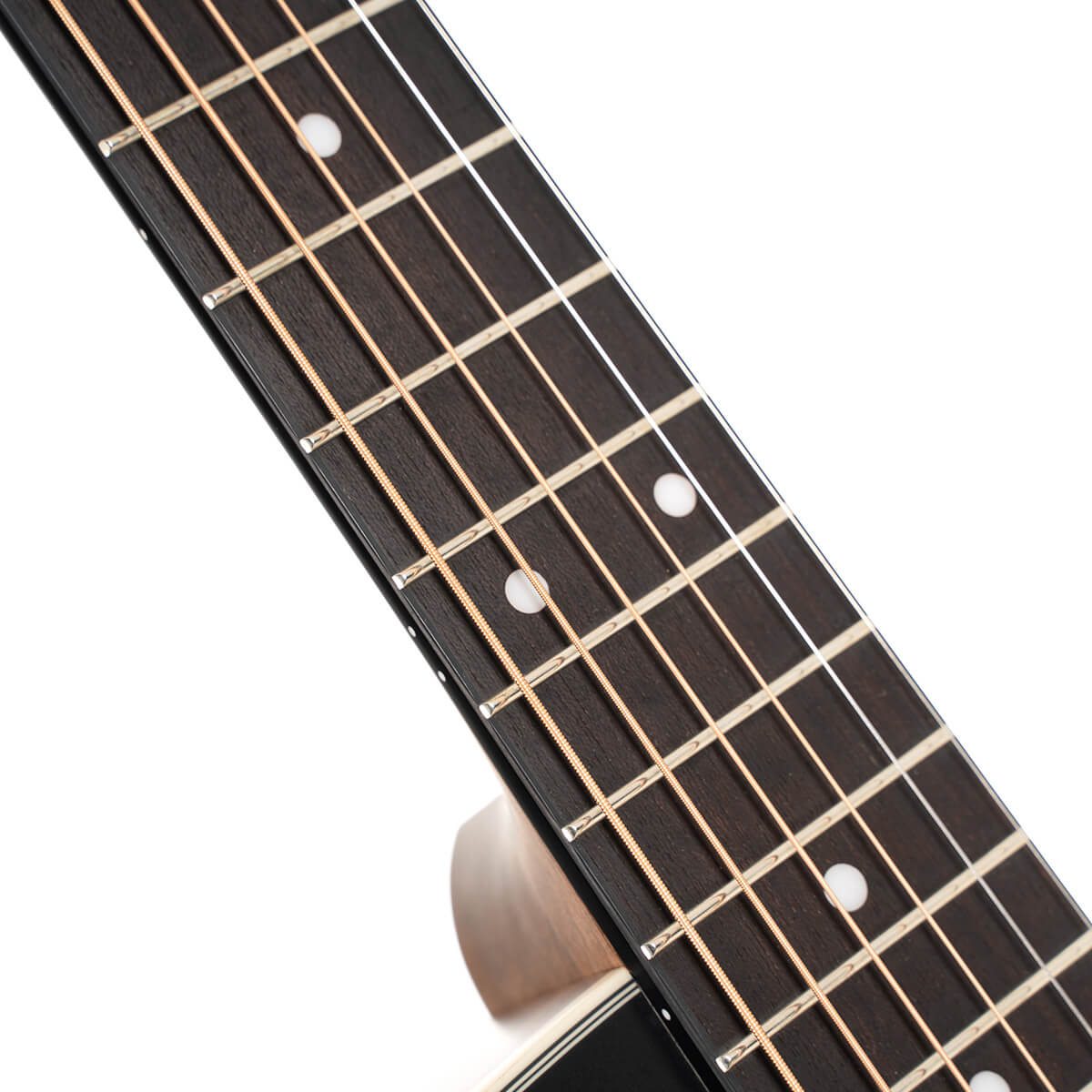 Close-up of an acoustic guitar neck showing six strings, metal frets, and white dot inlays on a dark wooden fretboard.