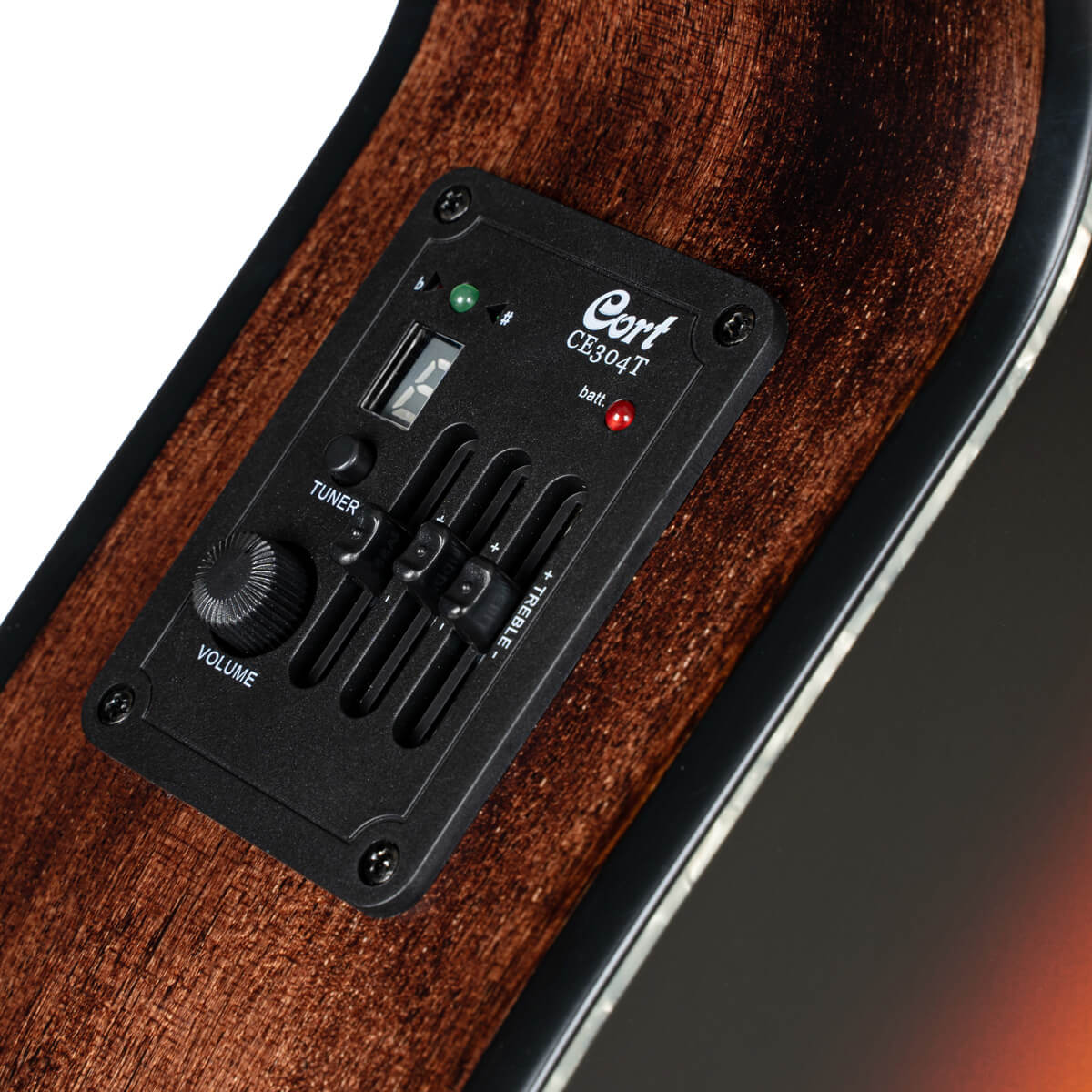 Close-up of an acoustic guitar’s built-in preamp panel with volume knob, tuner button, three sliders, LED lights, and a digital display.