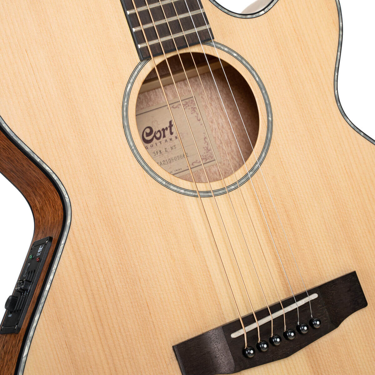 Light wood acoustic guitar with a cutaway body, visible sound hole label, dark bridge, and electronic controls on the side.