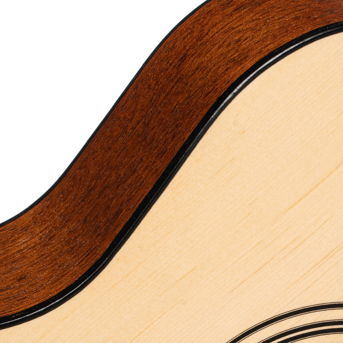 Curved edge of an acoustic guitar shows light wood top, dark brown sides, and thin black inlay between the surfaces.
