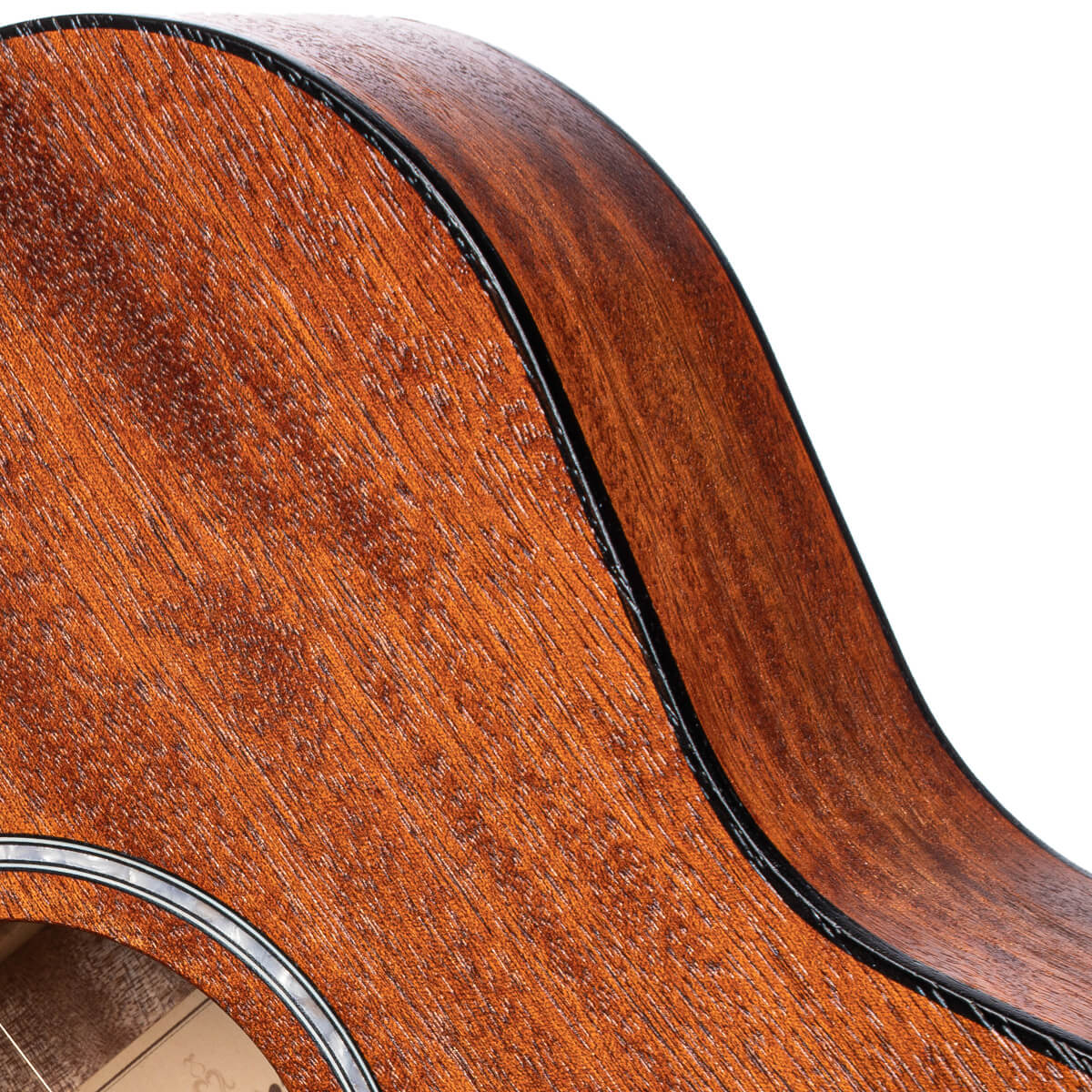 Curved side and front edge of a wooden acoustic guitar with a reddish-brown, textured finish and a black binding strip.