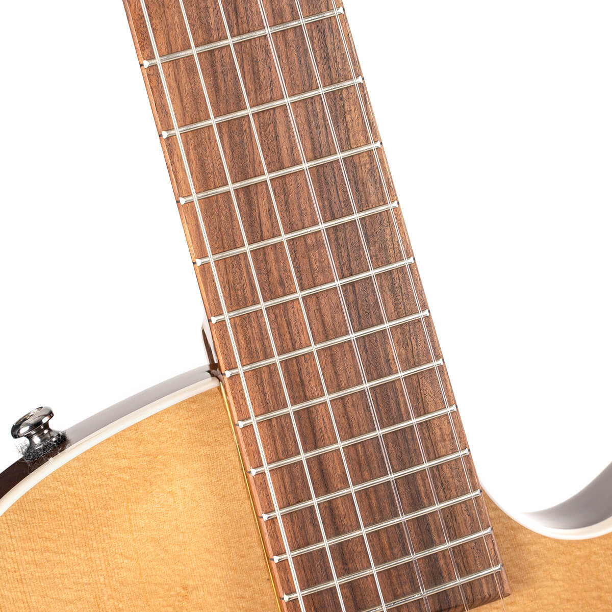 Close-up of a classical guitar’s neck and upper body, showing the frets, wooden fingerboard, and part of the light-colored top.
