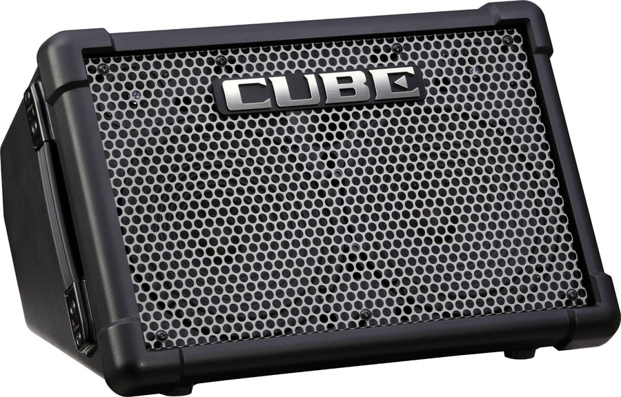 Ampli noir, grille en métal ajouré, logo argenté "CUBE" au centre, poignée latérale intégrée, coins renforcés en plastique.
