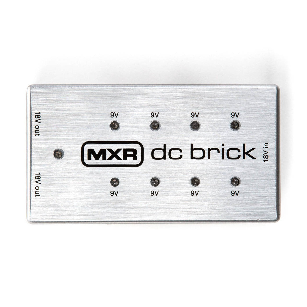 Rectangular silver effects pedal power supply labeled "MXR dc brick" with eight 9V outputs and two 18V outputs on a brushed metal surface.