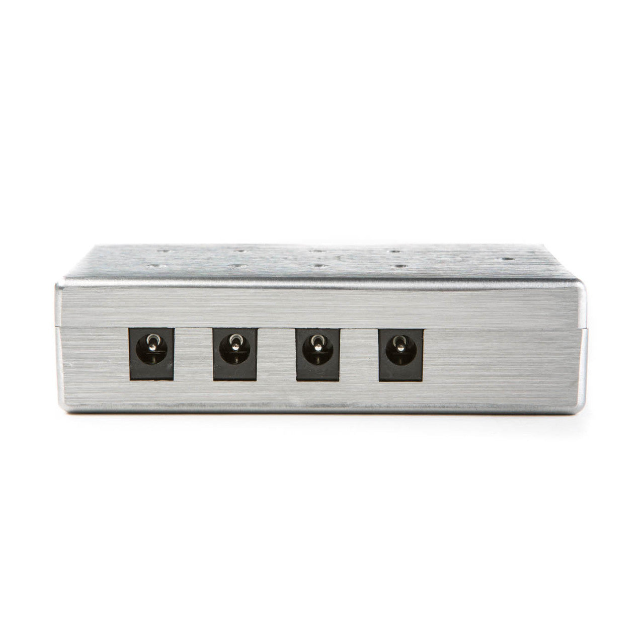 Rectangular metal effects pedal with five identical power input jacks in a row on one side.
