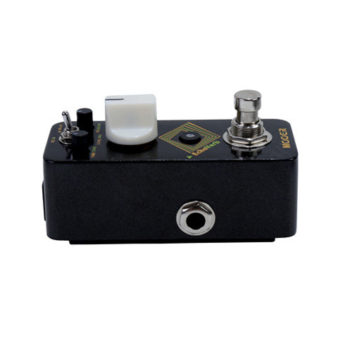 Compact black effects pedal with a large white knob, toggle switch, metal footswitch, and a single input jack on the side.