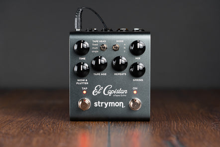 Strymon El Capistan dTape Echo FX pedal with six black control knobs, two toggle switches, two footswitches, and glowing red indicator lights.