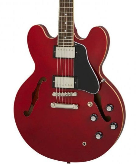 Red semi-hollow body electric guitar with two humbucker pickups, four black control knobs, a black pickguard, and f-shaped sound holes.