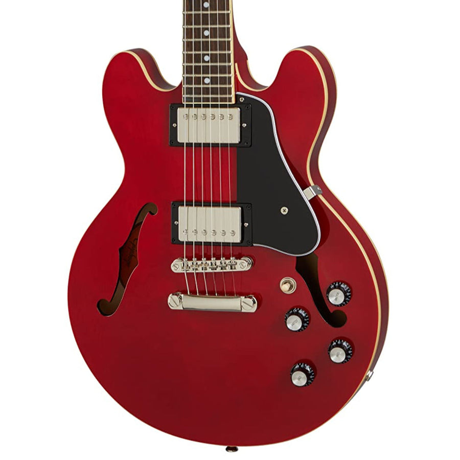 Red semi-hollow electric guitar with two humbucker pickups, black pickguard, four control knobs, and f-shaped sound holes on each side.