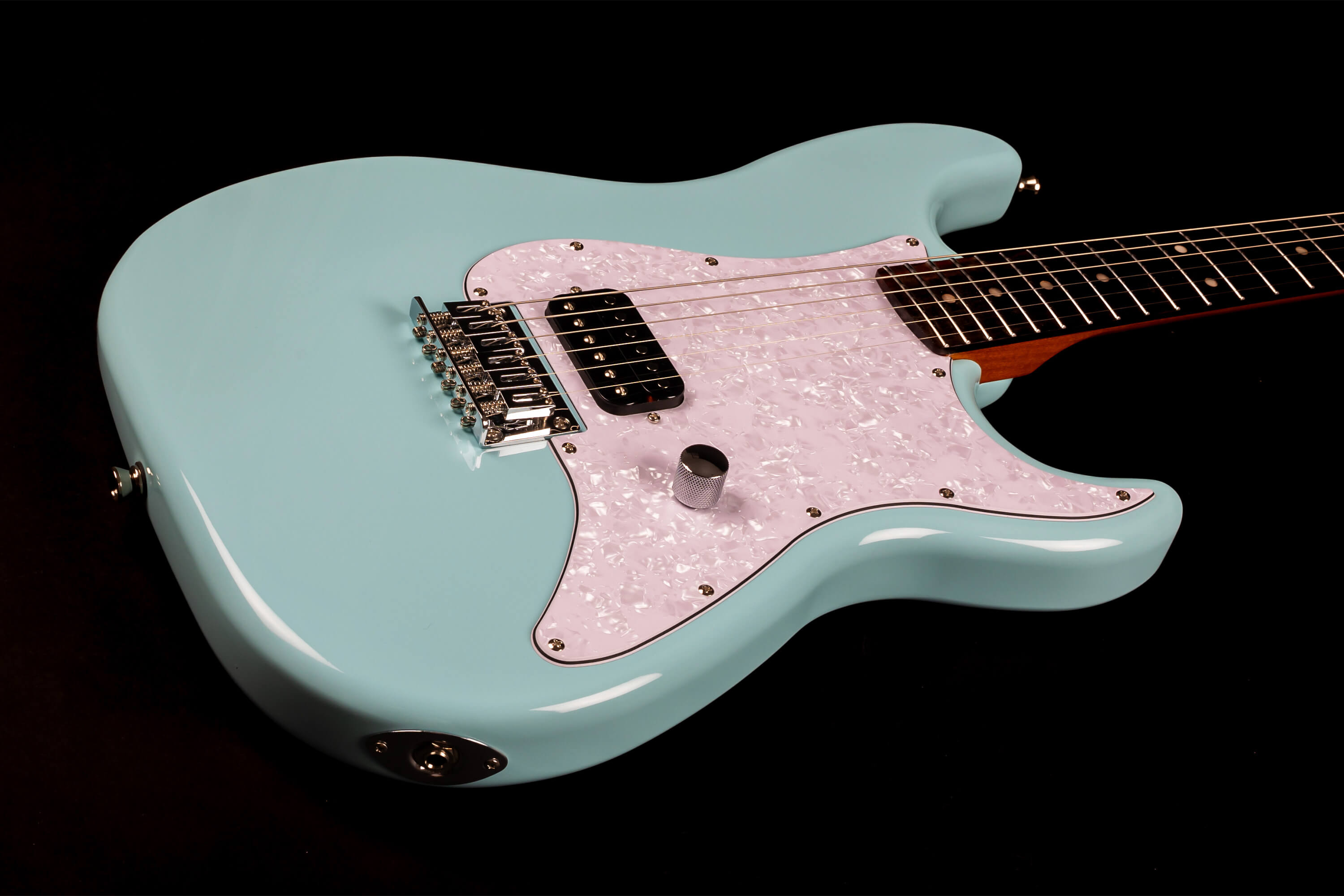 Light blue electric guitar with a pearloid white pickguard, single black pickup, chrome bridge, single control knob, and dark fingerboard.