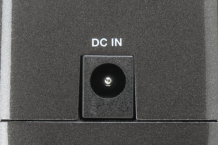 A close-up of a DC IN power jack on a pedal tuner, showing where to connect a power supply.
