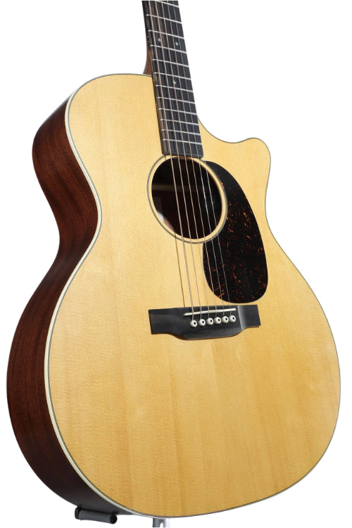 Light wood acoustic guitar with a dark side, cutaway body, black pickguard, six strings, and white bridge pins.