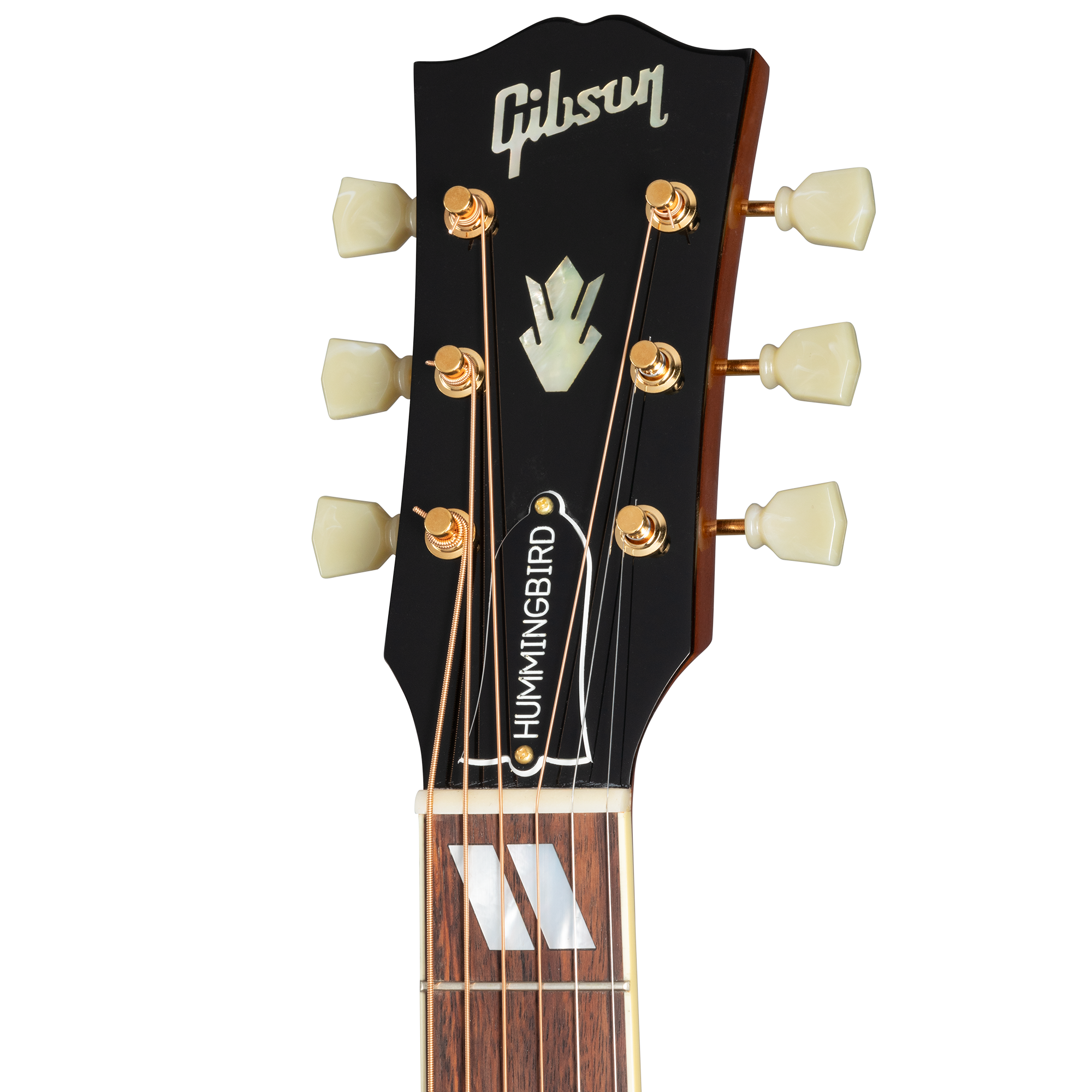 Close-up of a Gibson acoustic guitar headstock with gold tuning pegs, pearloid inlay, and "HUMMINGBIRD" truss rod cover.