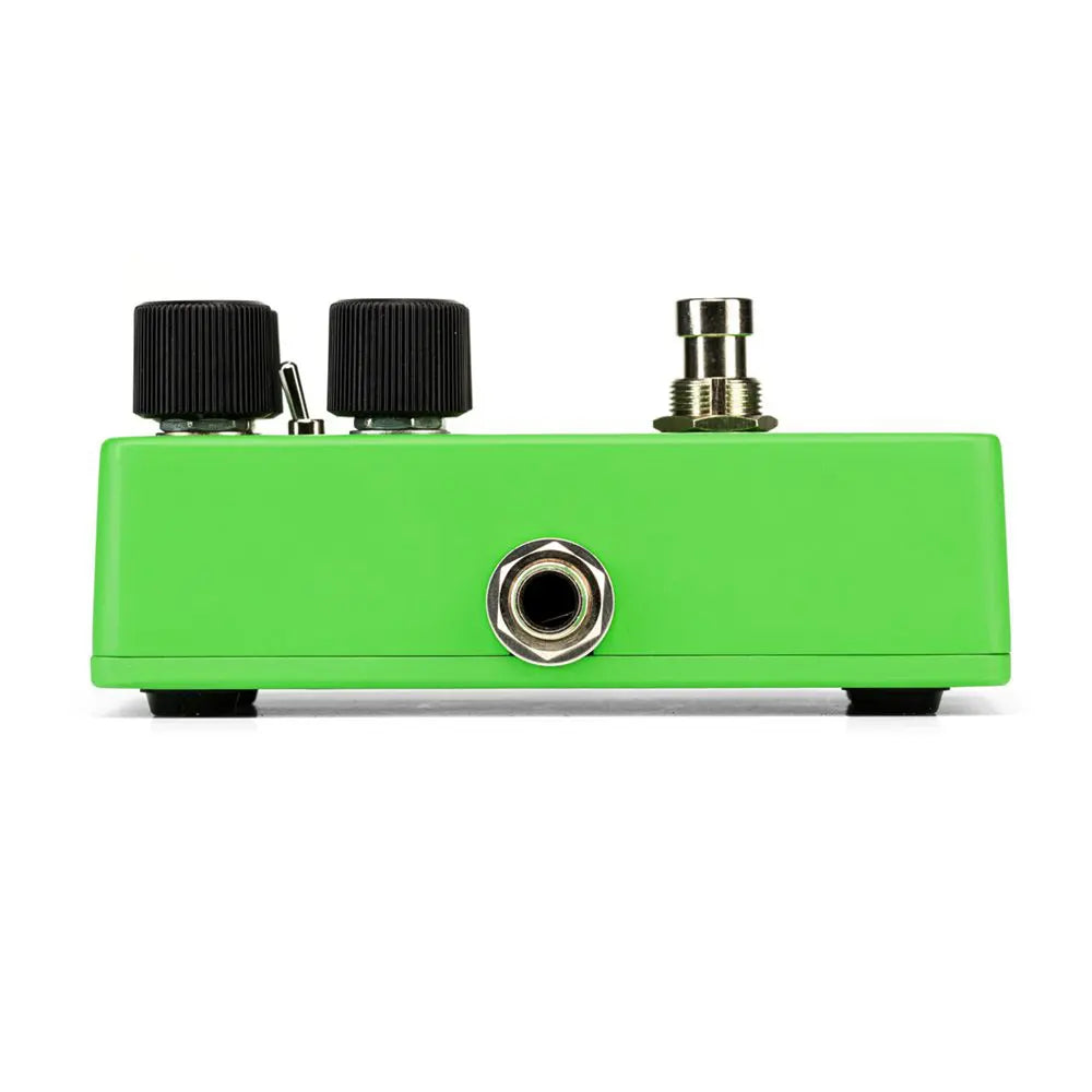 Bright green effects pedal with two black knobs, a small toggle switch, metal footswitch, and a quarter-inch input jack on the front panel.