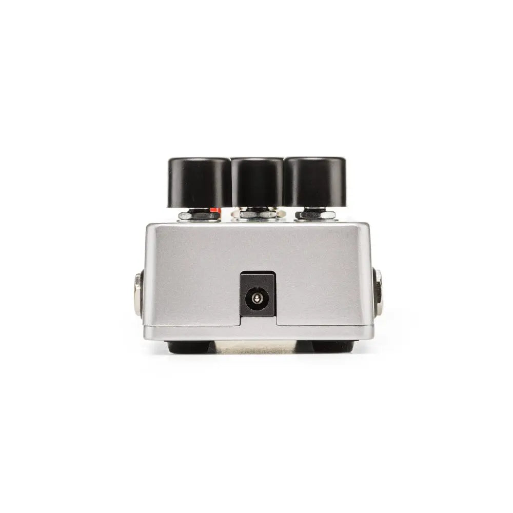 Silver effects pedal viewed from the rear, featuring a central power input jack and three large black control knobs on top.