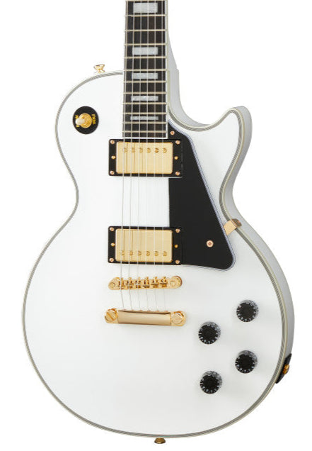White electric guitar with gold hardware, black pickguard, four black control knobs, and two rectangular gold pickups.
