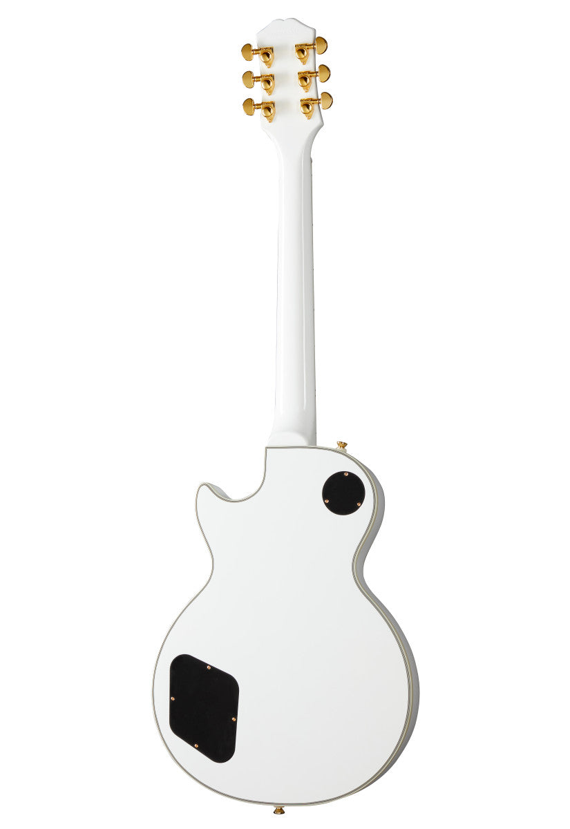 White electric guitar shown from the back, gold tuning pegs, two black control cavity covers on the body.