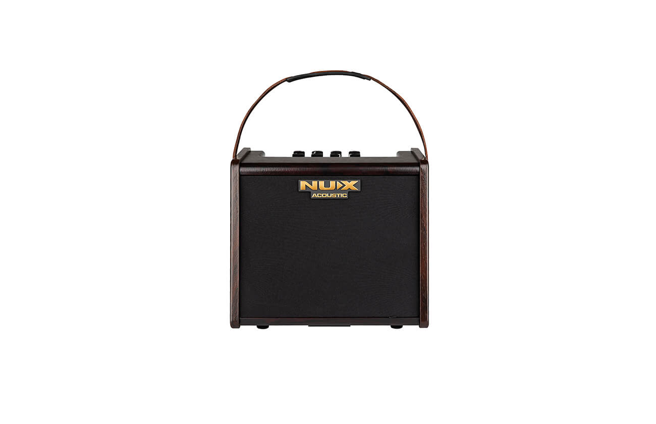 Compact black NUX acoustic amplifier with a dark brown frame, gold logo, top control knobs, and a curved carrying handle.