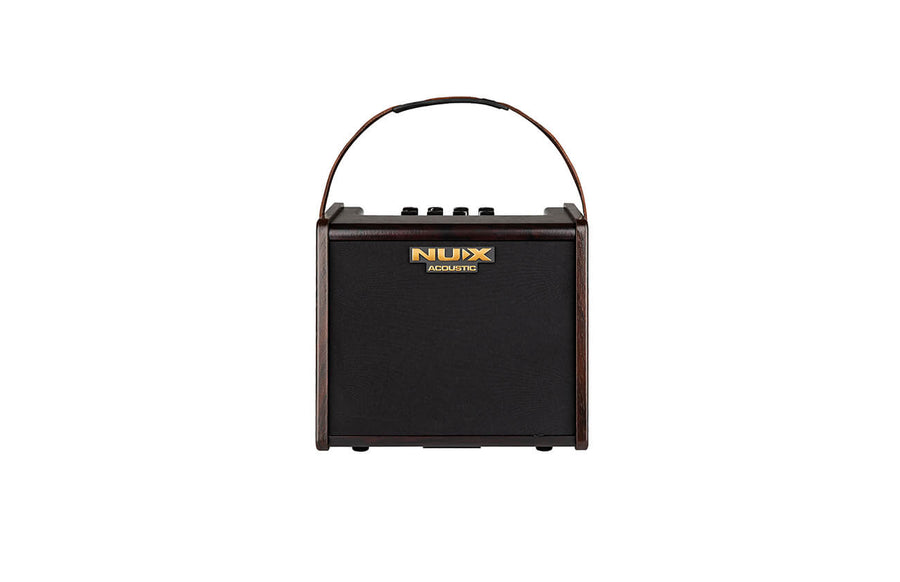 Compact black NUX acoustic amplifier with a dark brown frame, gold logo, top control knobs, and a curved carrying handle.