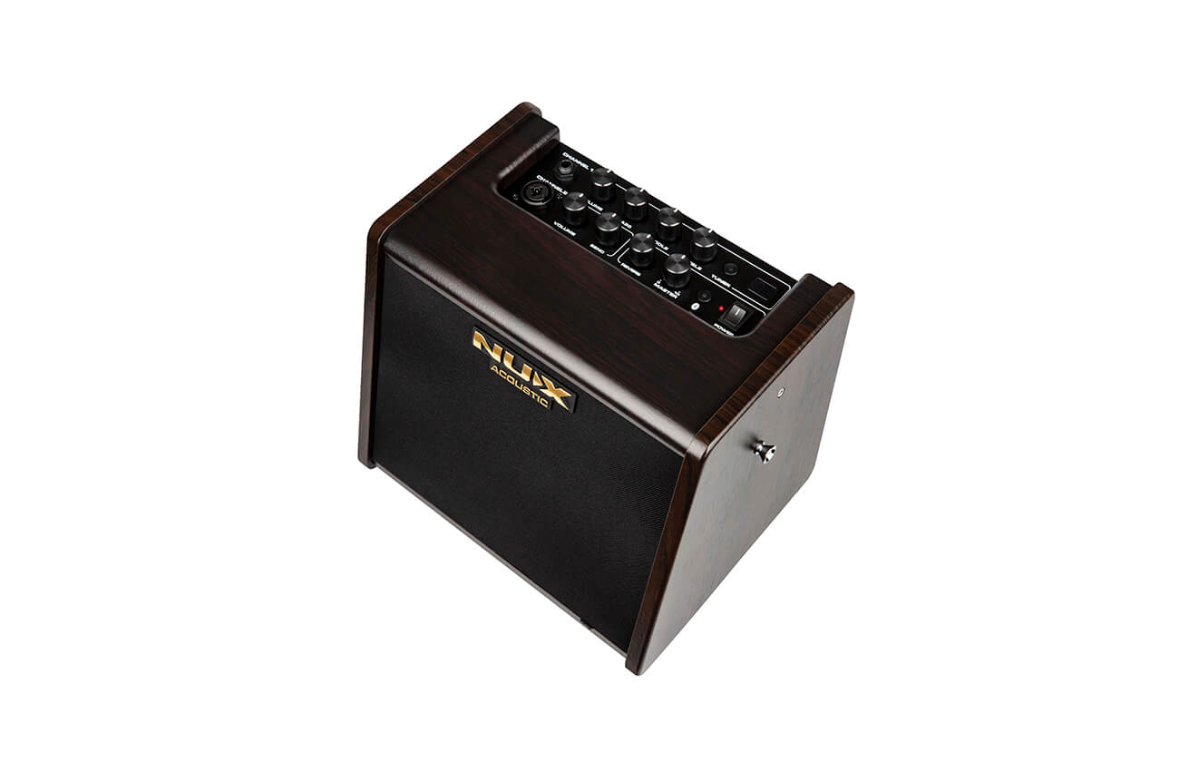 Compact wooden amplifier with black front panel, gold NUX Acoustic logo, and a control panel featuring multiple knobs and input ports on top.