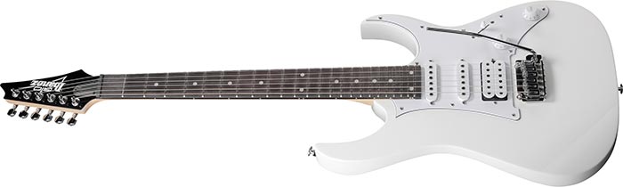 White electric guitar with a dark fretboard, double cutaway body, three pickups, whammy bar, and six tuning pegs on the headstock.