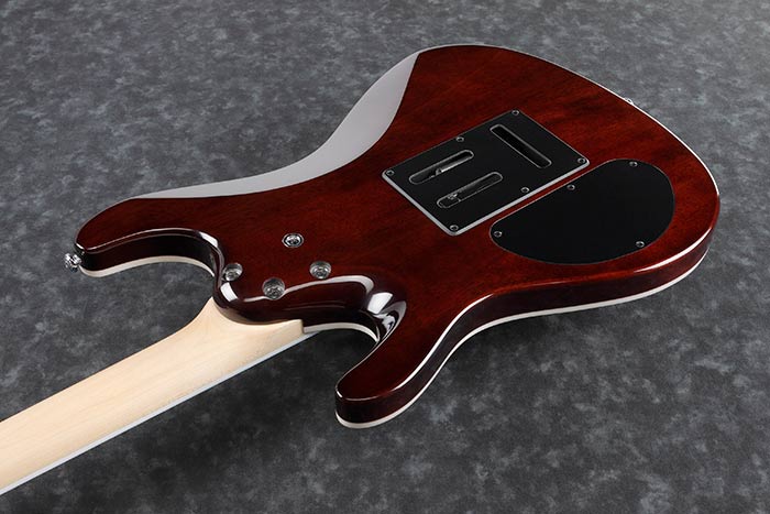 Rear view of an electric guitar with a glossy dark red body, light wood neck, and black plastic backplates for electronics and wiring.
