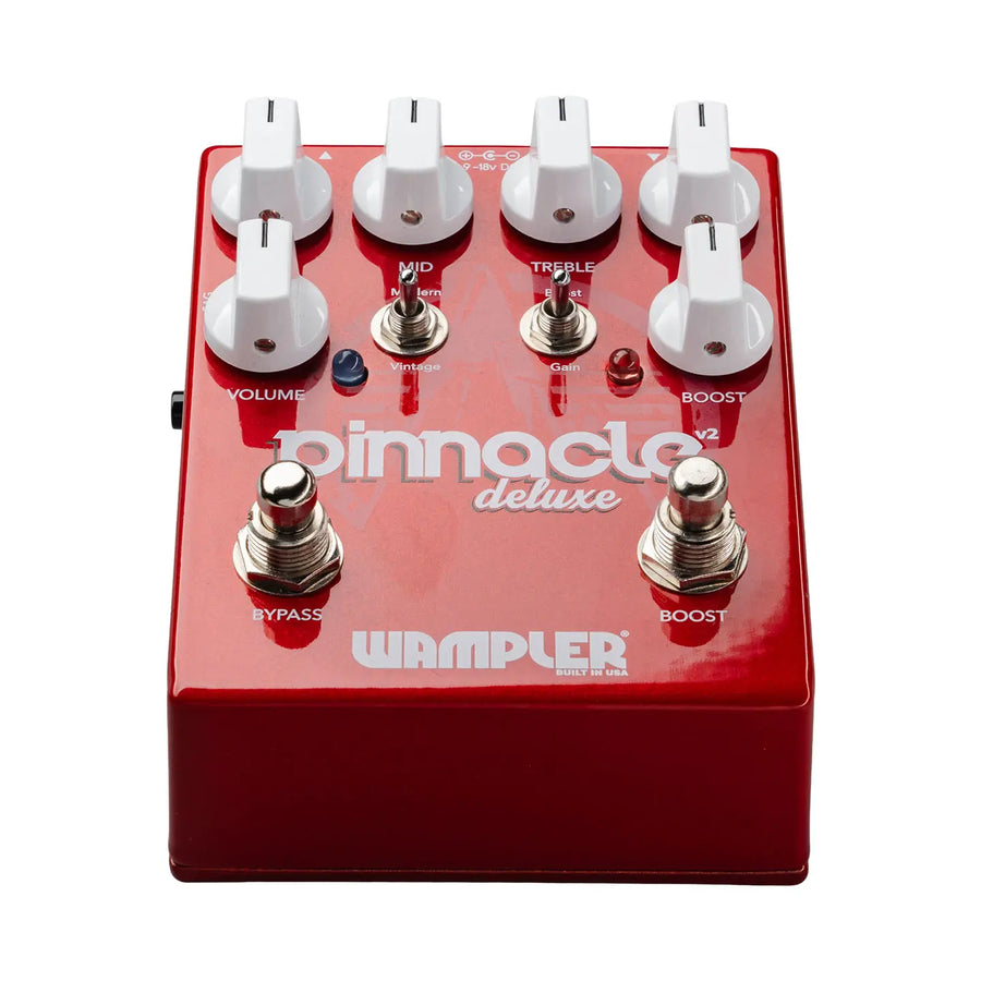 Red Wampler Pinnacle Deluxe FX pedal with six white knobs, two footswitches labeled Bypass and Boost, and two toggle switches for tone control.