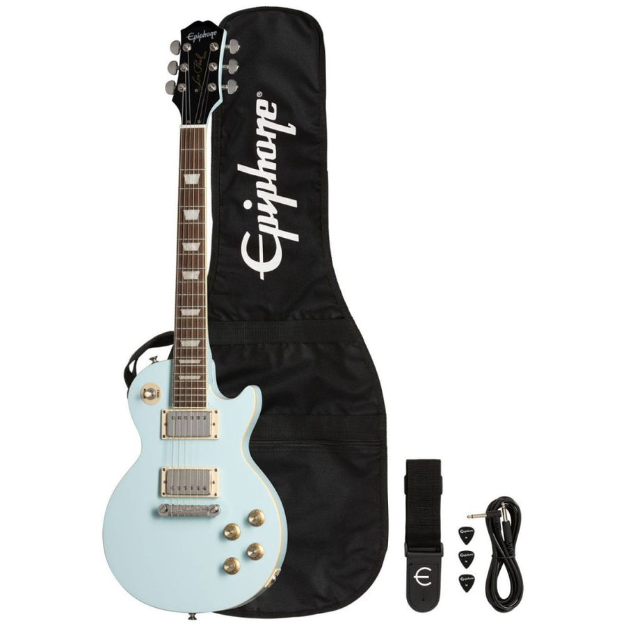Light blue Epiphone Les Paul electric guitar with gig bag, black strap, three picks, and cable arranged beside it.