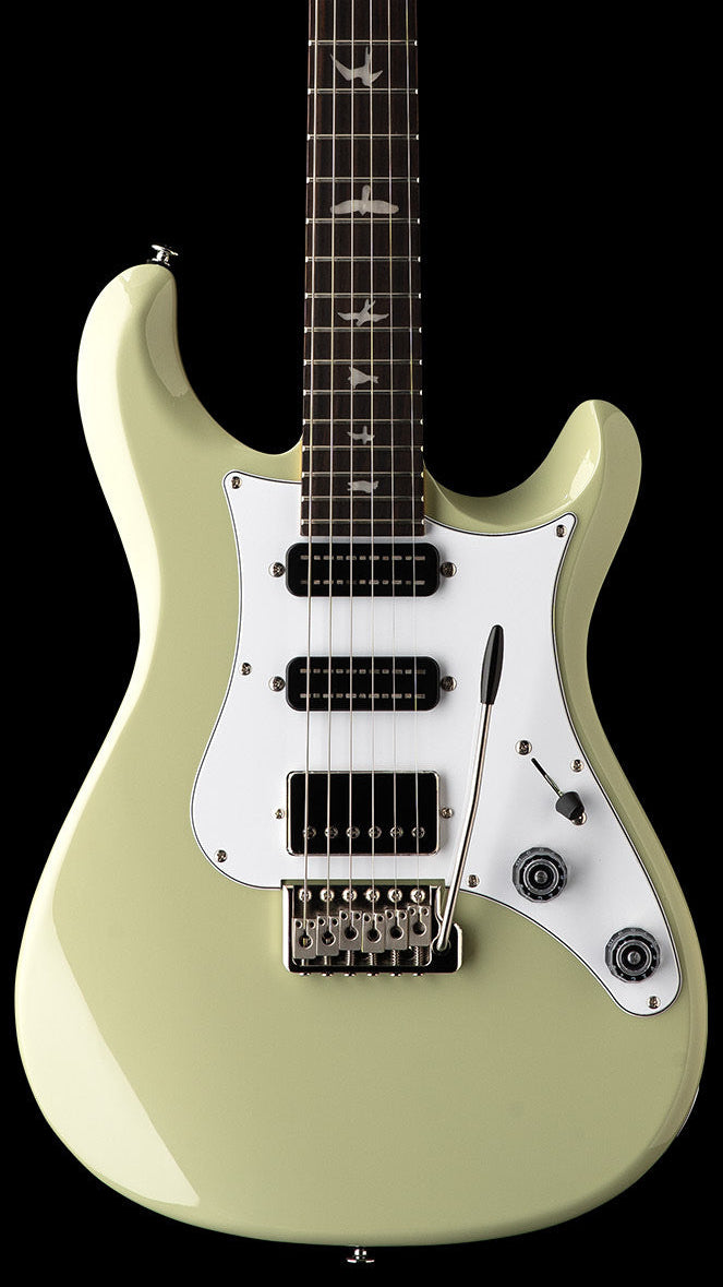 Paul Reed Smith electric guitar in light green with three black pickups, a white pickguard, and bird inlays on the dark fingerboard.