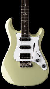 Paul Reed Smith electric guitar in light green with three black pickups, a white pickguard, and bird inlays on the dark fingerboard.