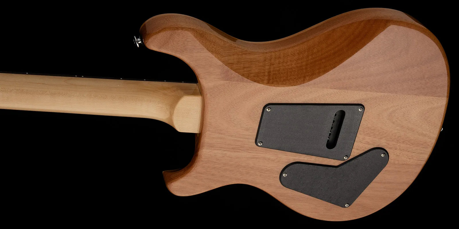 Light natural wood electric guitar back with two black rectangular plastic plates covering electronic cavities, smooth curved body and visible wood grain.