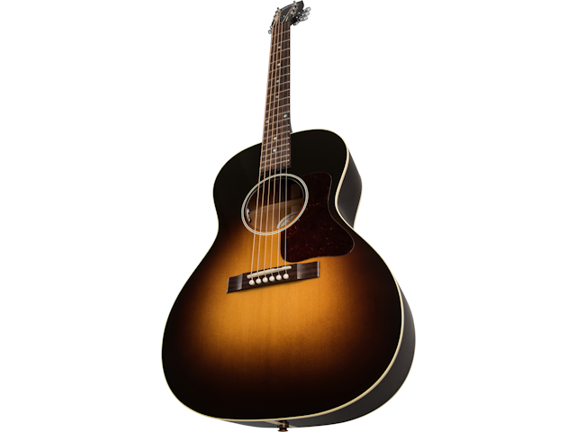 Sunburst acoustic guitar with a rounded body, six strings, dot inlays on the neck, and a tortoiseshell pickguard next to the sound hole.