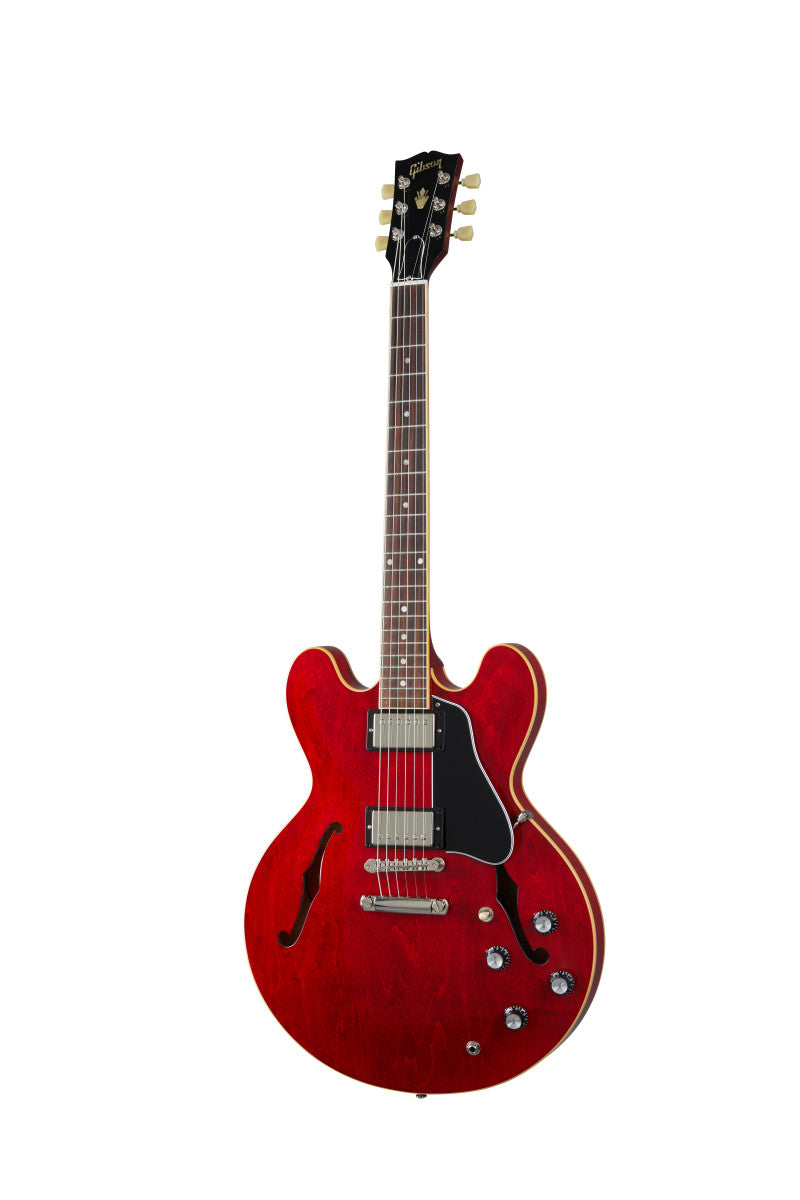 Red semi-hollow electric guitar with two humbucker pickups, black pickguard, four control knobs, and f-shaped sound holes on the body.