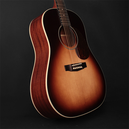 Dreadnought acoustic guitar with a glossy sunburst finish, dark edges, six strings, and a rounded body against a plain black background.