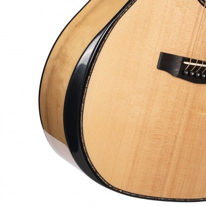Curved wooden body of an acoustic guitar with a light finish, black binding, and part of the bridge and strings visible.
