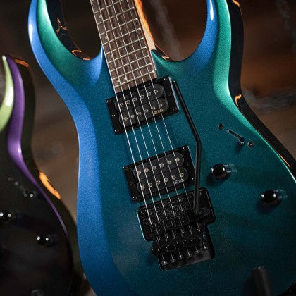 Electric guitar with a glossy blue-green finish, two humbucker pickups, black hardware, and a Floyd Rose style tremolo bridge.