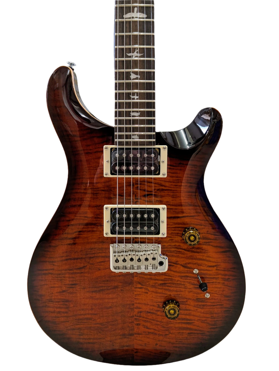 Electric guitar with a brown sunburst finish, two humbucker pickups, bird inlays on the fretboard, and gold control knobs.